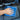 A hand using a blue microfiber cloth for car & bike on a car seat for effective cleaning